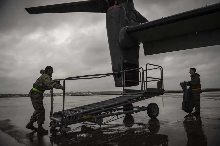 Airman 1st Class Joseph Cervantes, 801st Special Operations Aircraft Maintenance Squadron crew chief, positions air stairs next to a CV-22B Osprey engine for routine maintenance at Hurlburt Field, Fla., Oct. 27, 2015.  The 801st SOAMXS’s mission is to perform all equipment maintenance in support of worldwide special operations missions. (U.S. Air Force photo by Senior Airman Christopher Callaway/Released)