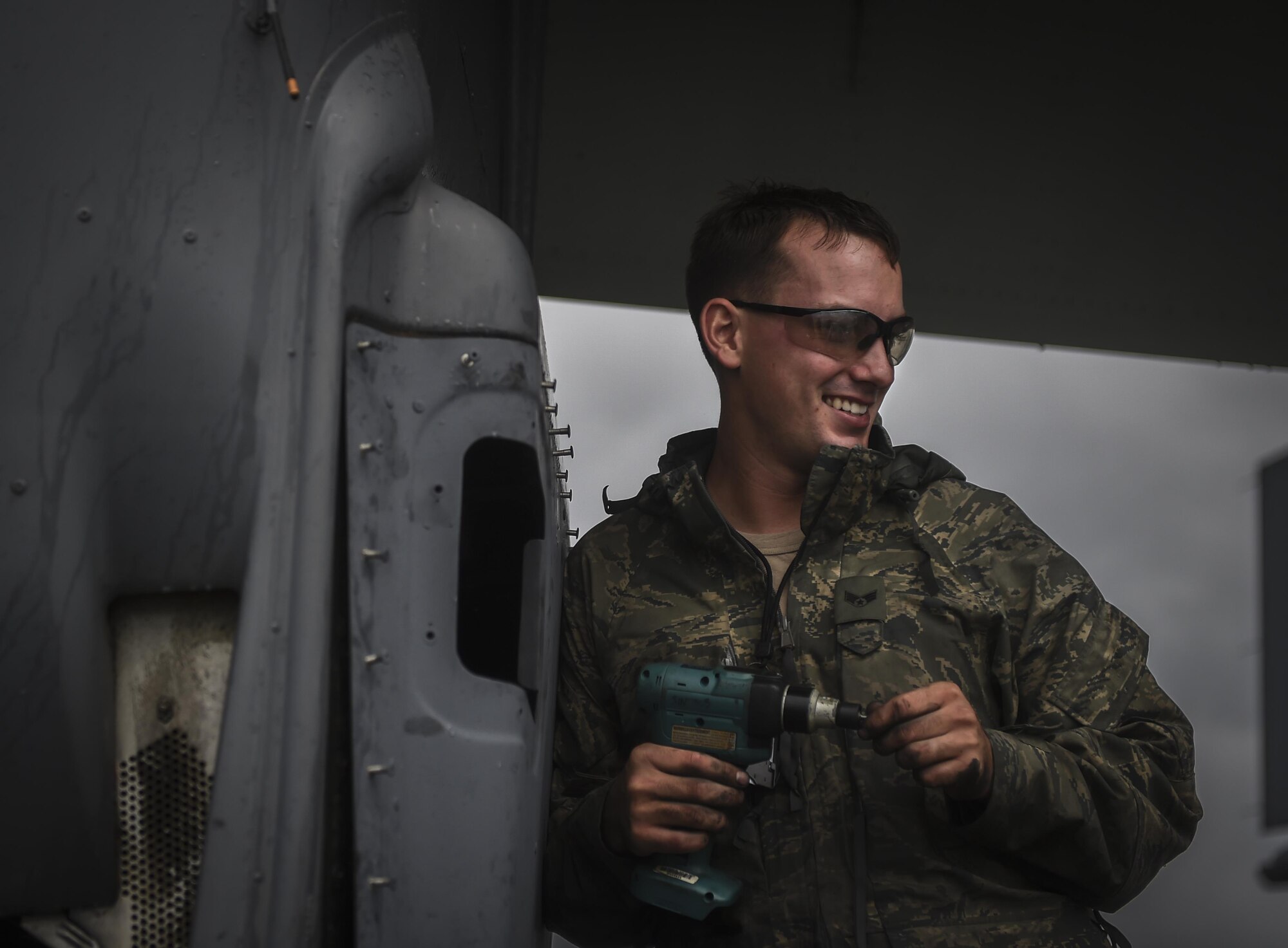Senior Airman Braden Ferrell, 801st Special Operations Aircraft Maintenance Squadron crew chief, performs routine maintenance on a CV-22B Osprey in the rain at Hurlburt Field, Fla., Oct. 27, 2015. Despite the after-effects of Hurricane Patricia, crew chiefs with the 801st SOAXMS continued performing maintenance to accomplish the mission. (U.S. Air Force photo by Senior Airman Christopher Callaway/Released)