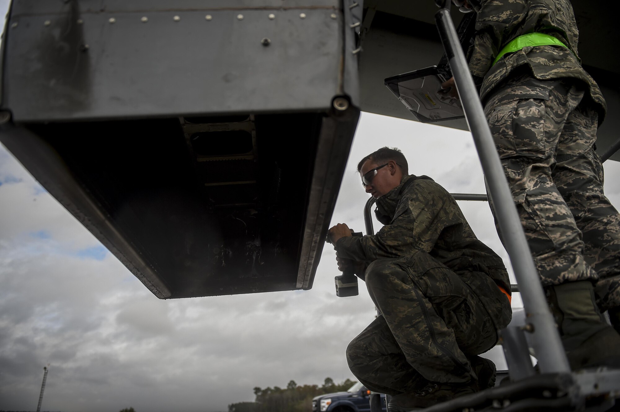 Senior Airman Braden Ferrell, 801st Special Operations Aircraft Maintenance Squadron crew chief, positions an infrared deflector panel back on to a CV-22B Osprey during routine maintenance at Hurlburt Field, Fla., Oct. 27, 2015. The 801st SOAMXS crew chiefs continued normal operations despite the after-effects of Hurricane Patricia at Hurlburt Field. (U.S. Air Force photo by Senior Airman Christopher Callaway/Released)