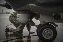 Senior Airman Daniel Gurka, 801st Special Operations Aircraft Maintenance Squadron crew chief, performs maintenance on a CV-22B Osprey tire at Hurlburt Field, Fla., Oct. 27, 2015. The 801st SOAMXS crew chiefs continued normal operations despite the after-effects of Hurricane Patricia at Hurlburt Field. (U.S. Air Force photo by Senior Airman Christopher Callaway/Released) 