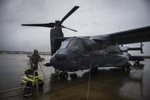 Senior Airman Daniel Gurka, 801st Special Operations Aircraft Maintenance Squadron crew chief, performs routine maintenance on a CV-22B Osprey at Hurlburt Field, Fla. Oct. 27, 2015. Despite the after-effects of Hurricane Patricia, crew chiefs with the 801st SOAXMS continued performing maintenance to accomplish the mission. (U.S. Air Force photo by Senior Airman Christopher Callaway/Released) 