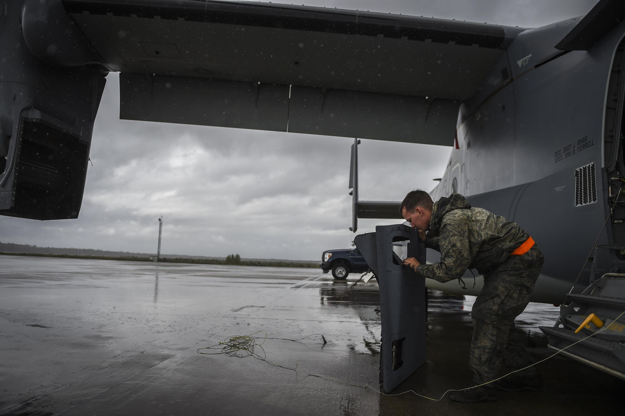 Senior Airman Braden Ferrell, 801st Special Operations Aircraft Maintenance Squadron crew chief, prepares to reattach an infrared deflector panel on a CV-22B Osprey during routine maintenance at Hurlburt Field, Fla., Oct. 27, 2015. The Osprey is a tiltrotor aircraft that combines the vertical takeoff, hover and vertical landing qualities of a helicopter with the long-range, fuel efficiency and speed characteristics of a turboprop aircraft. (U.S. Air Force photo by Senior Airman Christopher Callaway/Released) 