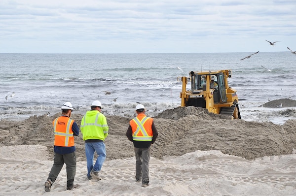 U.S. Army Corps of Engineers contractors place sand along Smith Point Park coastline in Suffolk County, Long Island, N.Y.