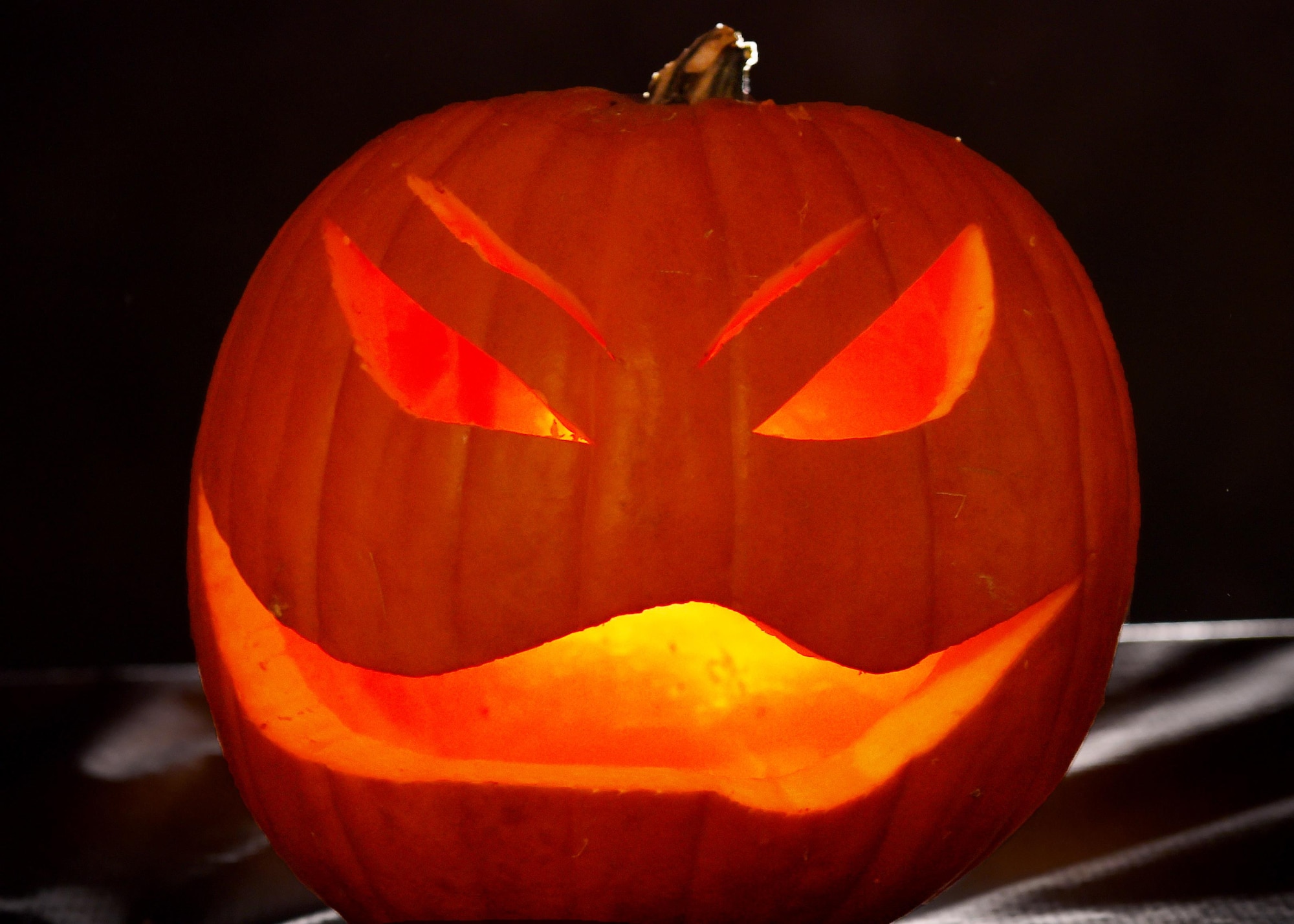 ALTUS AIR FORCE BASE, Okla. – Light illuminates a jack-o-lantern, Oct. 29, 2015. Fall is the time for fun but it is important to always stay safe. Use heatless artificial lights instead of candles to light jack-o-lanterns  . (U.S. Air Force photo by Airman 1st Class Kirby Turbak/Released)