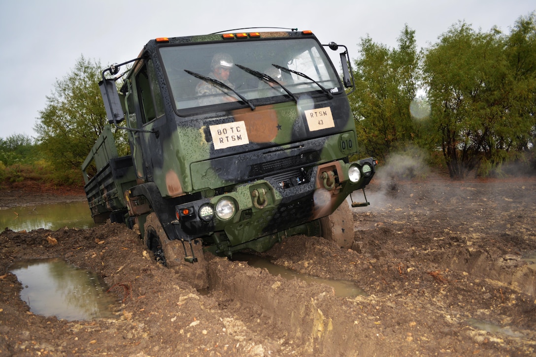 Instructors from Regional Training Site Maintenance-Fort Hood, Texas, purposely wedge a vehicle into a pond to teach students how to properly and safely recover and tow it as part of the Wheeled Vehicle Recovery Course, Oct. 22, 2015.