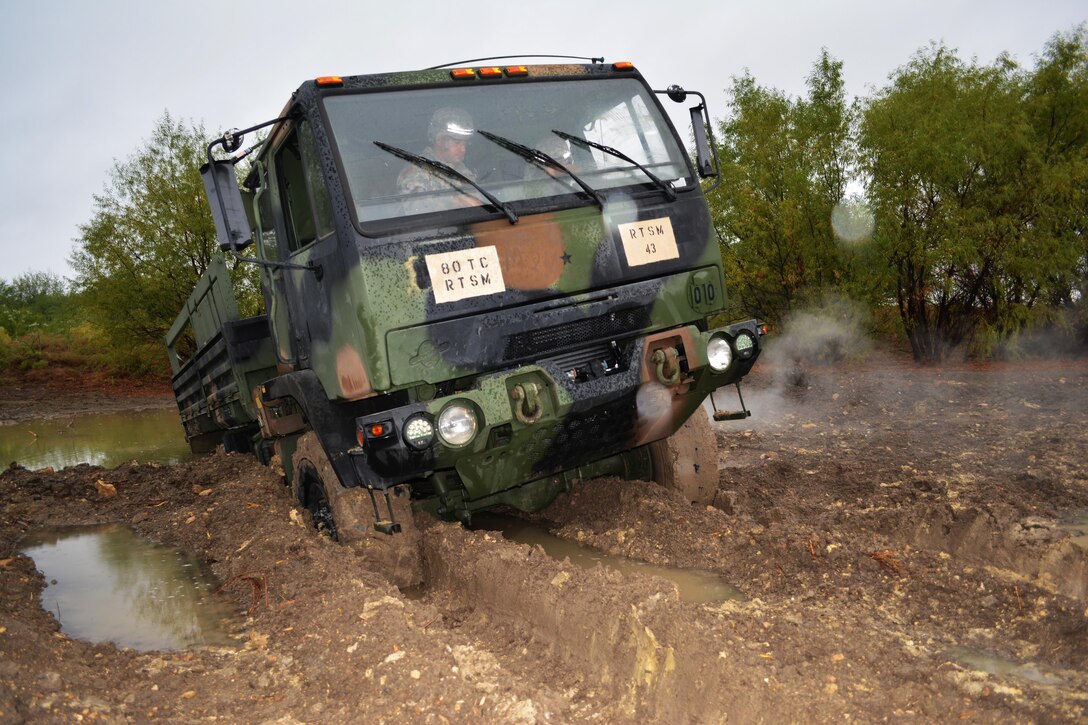 Instructors from Regional Training Site Maintenance-Fort Hood, Texas, purposely wedge a vehicle into a pond to teach students how to properly and safely recover and tow it as part of the Wheeled Vehicle Recovery Course, Oct. 22, 2015.