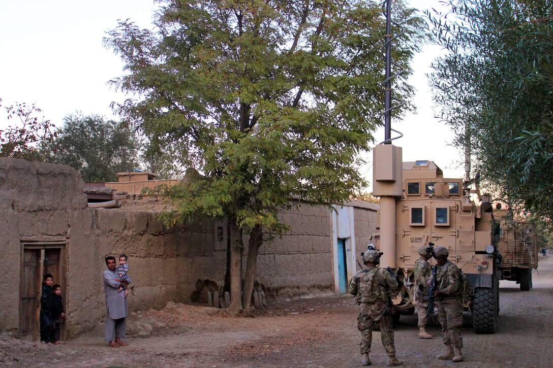 U.S., Czech and Afghan soldiers patrol and clear routes through a village in Parwan province, Afghanistan, Oct. 20, 2015. The U.S. soldiers are assigned to the 10th Mountain Division. The soldiers conducted the mission to help disrupt enemy forces and improve force protection for all team members on Bagram Airfield. U.S. Army photo by Sgt. 1st Class David Wheeler