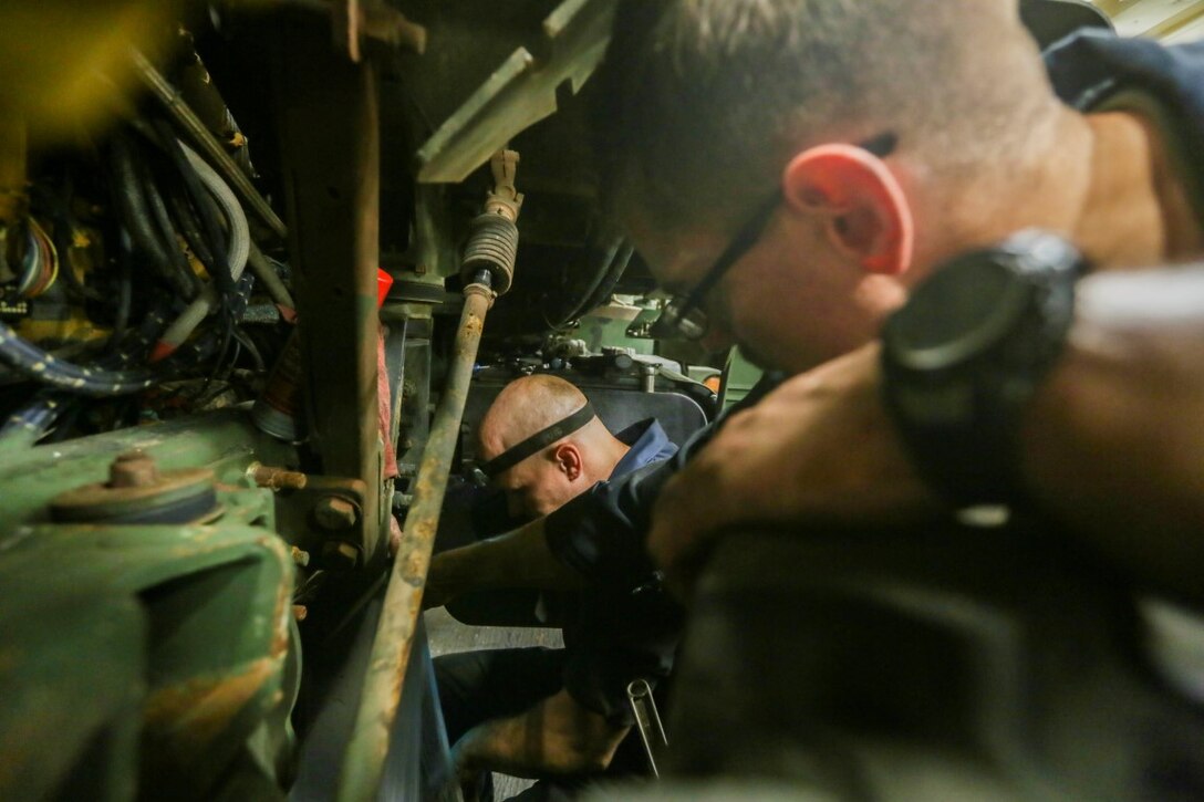 GULF OF ADEN (Oct. 27, 2015) U.S. Marine Sgt. Rodney Gleisner, left, and Sgt. Benjamin Tingle perform second-echelon vehicle maintenance on a Medium Tactical Vehicle Replacement aboard the USS Anchorage (LPD 23). Tingle and Gleisner are motor transportation mechanics with Combat Logistics Battalion 15, 15th Marine Expeditionary Unit. The 15th MEU, embarked on the ships of the Essex Amphibious Ready Group, is deployed to maintain regional security in the U.S. 5th Fleet area of operations.  (U.S. Marine Corps photo by Sgt. Jamean Berry/Released)