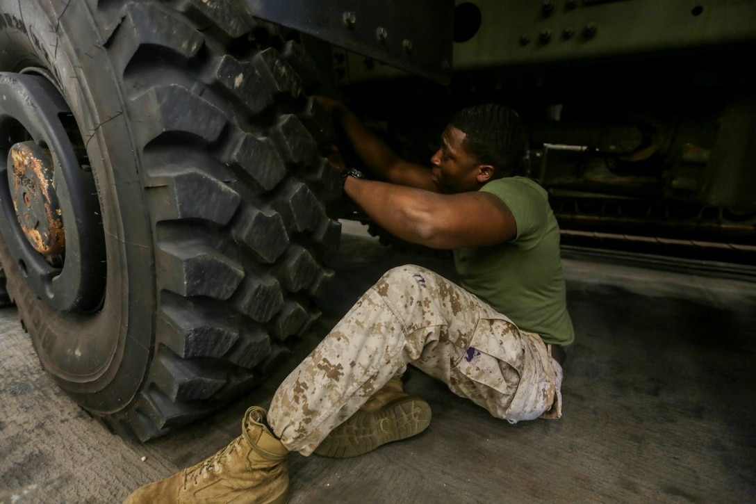 GULF OF ADEN (Oct. 27, 2015) U.S. Marine Cpl. Jeff Louis performs first-echelon preventative maintenance checks and services on a Medium Tactical Vehicle Replacement aboard the USS Anchorage (LPD 23).   Louis is a motor transportation operator with Combat Logistics Battalion 15, 15th Marine Expeditionary Unit.   The 15th MEU, embarked on the ships of the Essex Amphibious Ready Group, is deployed to maintain regional security in the U.S. 5th Fleet area of operations.  (U.S. Marine Corps photo by Sgt. Jamean Berry/Released)