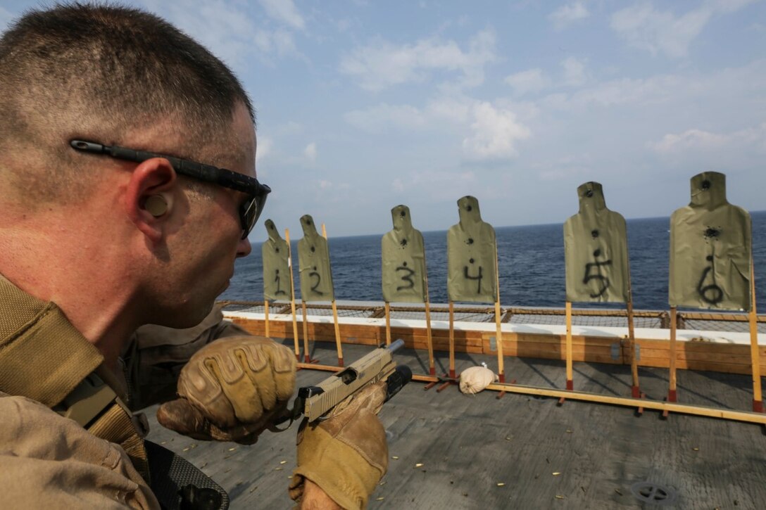 GULF OF ADEN (Oct. 28, 2015) U.S. Marine Capt. John Garlasco fires an M45A1 .45 Cal pistol during a deck shoot aboard the USS Anchorage (LPD 23).  Garlasco is the commanding officer of the Force Reconnaissance Detachment, 15th Marine Expeditionary Unit.   Anchorage is part of the Essex Amphibious Ready Group and, with the embarked 15th Marine Expeditionary Unit, is deployed in support of maritime security operations and theater security cooperation efforts in the U.S. 5th Fleet area of operations.  (U.S. Marine Corps photo by Sgt. Jamean Berry/Not Released)