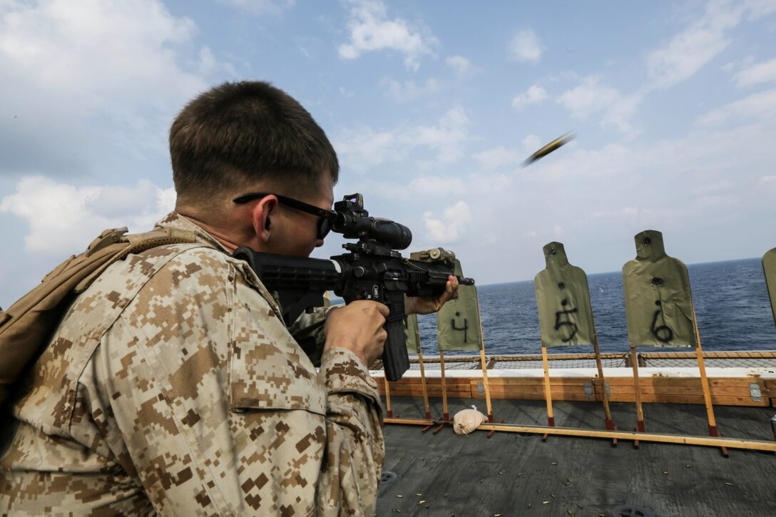 GULF OF ADEN (Oct. 28, 2015) U.S. Marine Lance Cpl. Kenneth Klee fires an infantry automatic rifle during a deck shoot aboard the USS Anchorage (LPD 23).  Klee is an IAR gunner with the 15th Marine Expeditionary Unit’s Maritime Raid Force. The 15th MEU, embarked on the ships of the Essex Amphibious Ready Group, is deployed to maintain regional security in the U.S. 5th Fleet area of operations. (U.S. Marine Corps photo by Sgt. Jamean Berry/Released)