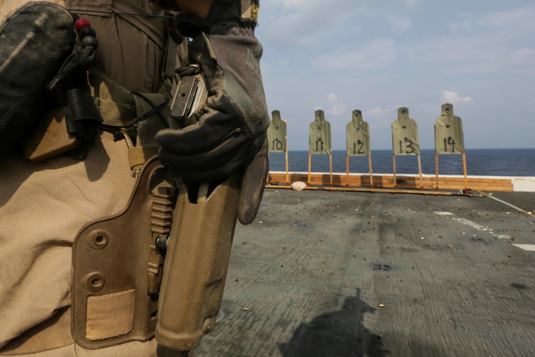 GULF OF ADEN (Oct. 28, 2015) A  U.S. Marine with the 15th Marine Expeditionary Unit’s Force Reconnaissance Detachment, prepares to draw an M45 1911 A1 pistol during a deck shoot aboard the USS Anchorage (LPD 23). The 15th MEU, embarked on the ships of the Essex Amphibious Ready Group, is deployed to maintain regional security in the U.S. 5th Fleet area of operations. (U.S. Marine Corps photo by Sgt. Jamean Berry/Released)