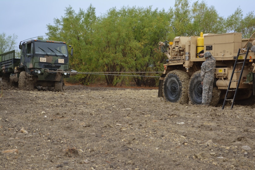 Students attending the Wheeled Vehicle Recovery Course at Regional Training Site Maintenance-Fort Hood, Texas, drag a truck out of mud, Oct. 23, 2015. The course teaches Army mechanics how to properly and safely recover and tow vehicles that may be stuck or inoperable.