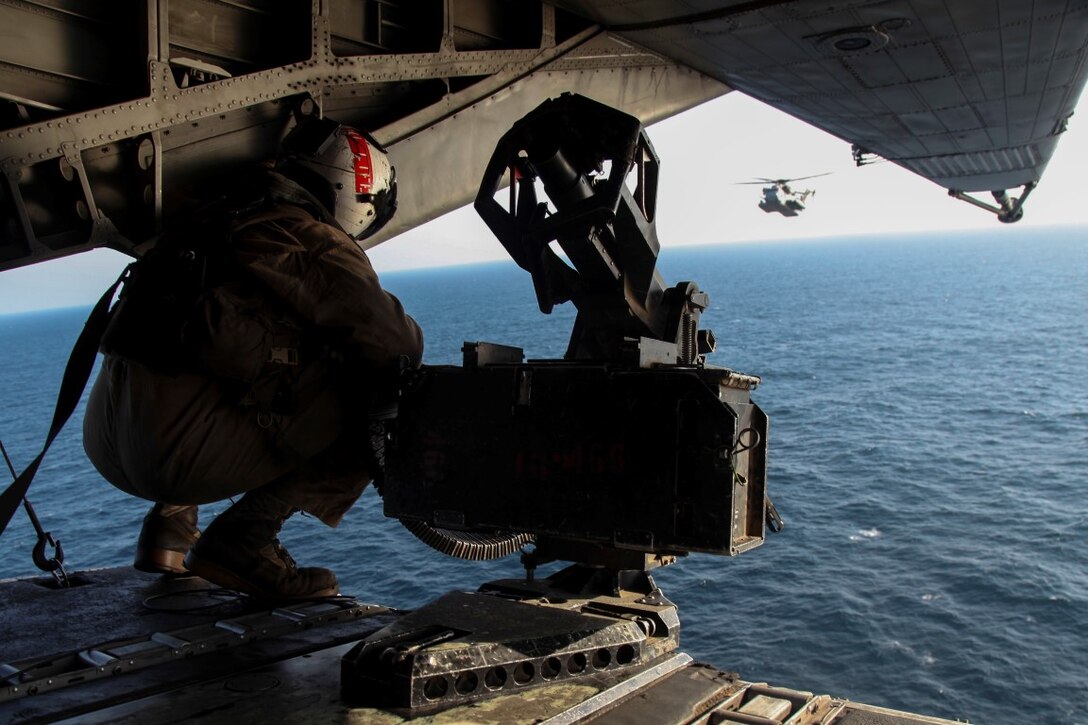 GULF OF OMAN (Oct. 29, 2015) U.S. Marine Sgt. Gilbert Hopper looks out over the ocean while flying aboard a CH-53E Super Stallion. Hopper is a crew chief with Marine Medium Tiltrotor Squadron 161 (Reinforced), 15th Marine Expeditionary Unit. The 15th MEU, embarked aboard the ships of the Essex Amphibious Ready Group, is deployed to maintain regional security in the U.S. 5th Fleet area of operations. (U.S. Marine Corps photo by Cpl. Elize McKelvey/Released)