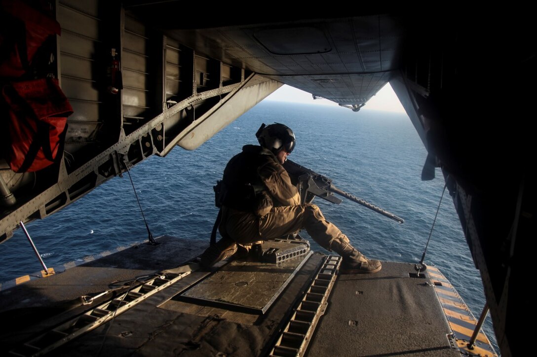 GULF OF OMAN  (Oct. 29, 2015) U.S. Marine Sgt. Gilbert Hopper provides security while flying aboard a CH-53E Super Stallion. Hopper is a crew chief with Marine Medium Tiltrotor Squadron 161 (Reinforced), 15th Marine Expeditionary Unit. The 15th MEU, embarked aboard the ships of the Essex Amphibious Ready Group, is deployed to maintain regional security in the U.S. 5th Fleet area of operations. (U.S. Marine Corps photo by Cpl. Elize McKelvey/Released)