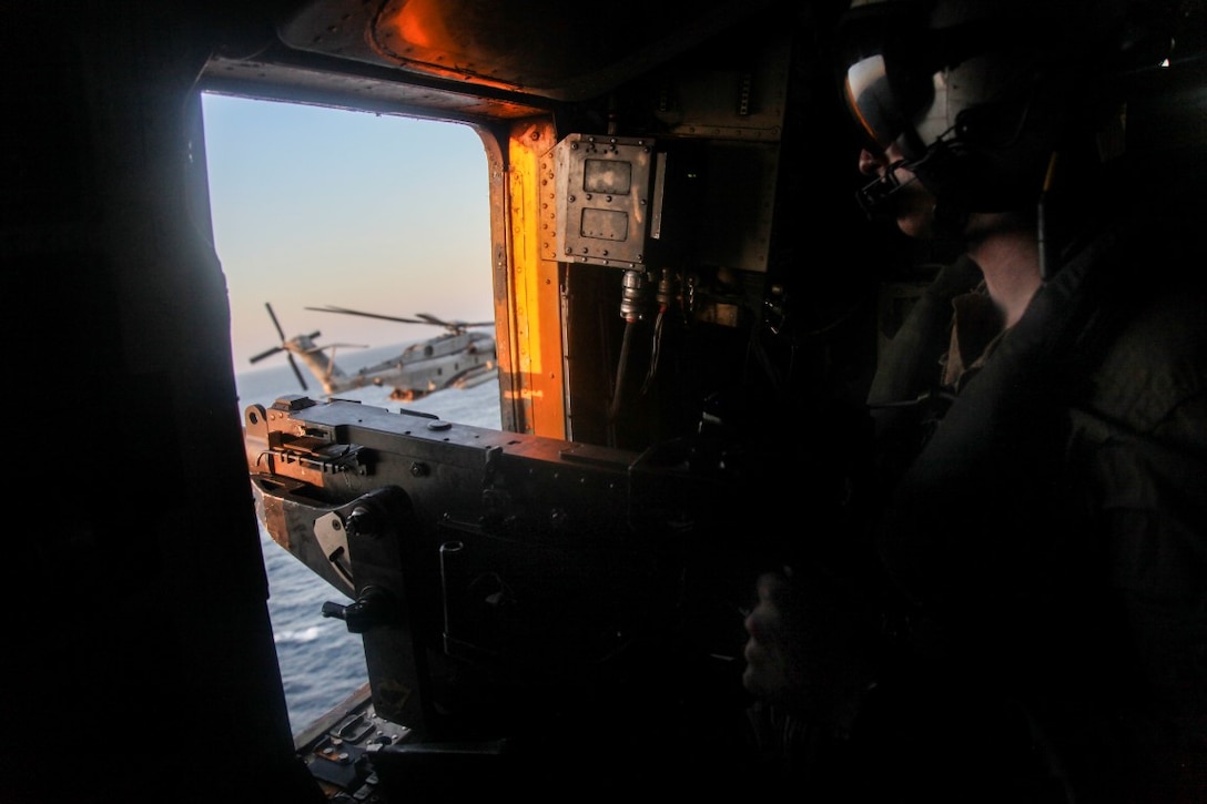 GULF OF OMAN (Oct. 29, 2015) U.S. Marine Sgt. Trevor Adams looks out for targets while flying in a CH-53E Super Stallion. Adams is a crew chief with Marine Medium Tiltrotor Squadron 161 (Reinforced), 15th Marine Expeditionary Unit. The 15th MEU, embarked aboard the ships of the Essex Amphibious Ready Group, is deployed to maintain regional security in the U.S. 5th Fleet area of operations. (U.S. Marine Corps photo by Cpl. Elize McKelvey/Released)