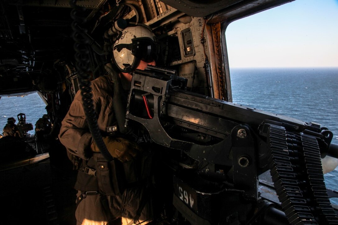 GULF OF OMAN (Oct. 29, 2015) U.S. Marine Sgt. Trevor Adams fires an M2 .50-caliber machine gun at targets while flying aboard a CH-53E Super Stallion. Adams is a crew chief with Marine Medium Tiltrotor Squadron 161 (Reinforced), 15th Marine Expeditionary Unit. The 15th MEU, embarked aboard the ships of the Essex Amphibious Ready Group, is deployed to maintain regional security in the U.S. 5th Fleet area of operations. (U.S. Marine Corps photo by Cpl. Elize McKelvey/Released)