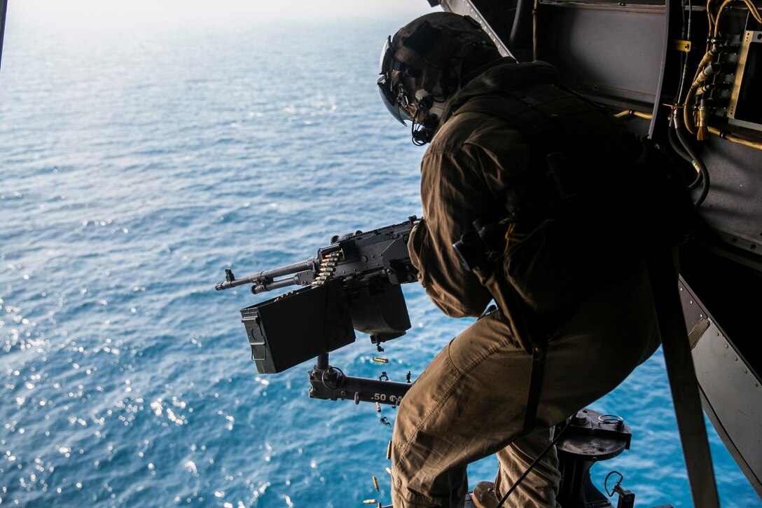 GULF OF OMAN (Oct. 29, 2015) U.S. Marine Cpl. Mitchell Hintz fires an M240 medium machine gun from an MV-22B Osprey. Hintz is a crew chief with Marine Medium Tiltrotor Squadron 161 (Reinforced), 15th Marine Expeditionary Unit. The Marines practiced firing at targets in the water to stay familiar with the weapon system and enhance their marksmanship. The 15th MEU, embarked on the ships of the Essex Amphibious Ready Group, is deployed to maintain regional security in the U.S. 5th Fleet area of operations. (U.S. Marine Corps photo by Sgt. Anna Albrecht/Released)