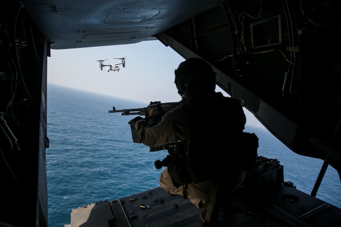 GULF OF OMAN (Oct. 29, 2015) U.S. Marine Cpl. Mitchell Hintz prepares to fire an M240 medium machine gun from an MV-22B Osprey. Hintz is a crew chief with Marine Medium Tiltrotor Squadron 161 (Reinforced), 15th Marine Expeditionary Unit. The Marines practiced firing at targets in the water to stay familiar with the weapon system and enhance their marksmanship. The 15th MEU, embarked on the ships of the Essex Amphibious Ready Group, is deployed to maintain regional security in the U.S. 5th Fleet area of operations. (U.S. Marine Corps photo by Sgt. Anna Albrecht/Released)