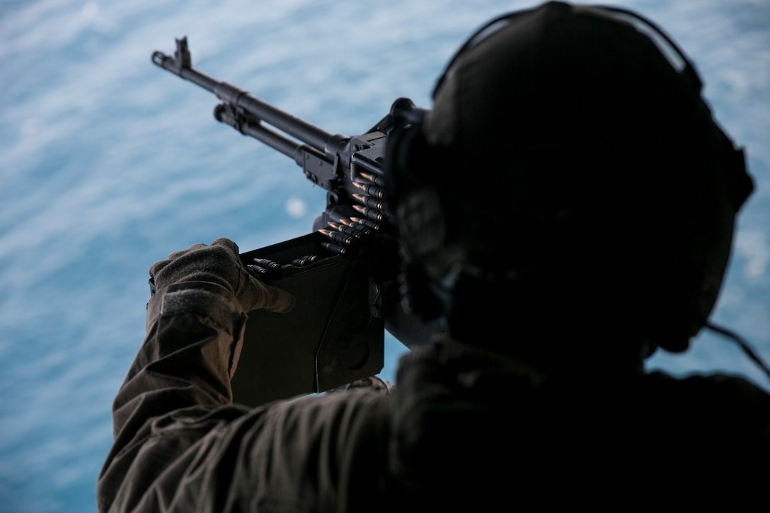 GULF OF OMAN (Oct. 29, 2015) U.S. Marine Cpl. Mitchell Hintz loads an M240 medium machine gun in an MV-22B Osprey. Hintz is a crew chief with Marine Medium Tiltrotor Squadron 161 (Reinforced), 15th Marine Expeditionary Unit. The Marines practiced firing at targets in the water to stay familiar with the weapon system and enhance their marksmanship. The 15th MEU, embarked on the ships of the Essex Amphibious Ready Group, is deployed to maintain regional security in the U.S. 5th Fleet area of operations. (U.S. Marine Corps photo by Sgt. Anna Albrecht/Released)