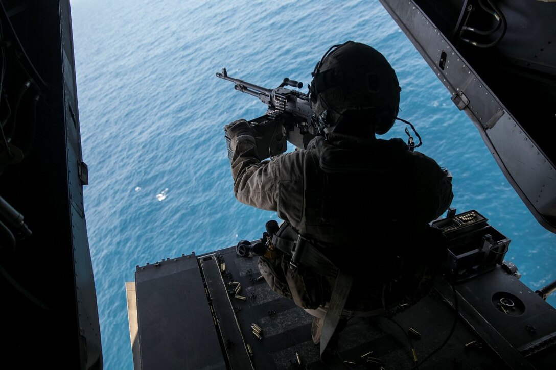 GULF OF OMAN (Oct. 29, 2015) U.S. Marine Cpl. Mitchell Hintz prepares to fire an M240 medium machine gun from an MV-22B Osprey. Hintz is a crew chief with Marine Medium Tiltrotor Squadron 161 (Reinforced), 15th Marine Expeditionary Unit. The Marines practiced firing at targets in the water to stay familiar with the weapon system and enhance their marksmanship. The 15th MEU, embarked on the ships of the Essex Amphibious Ready Group, is deployed to maintain regional security in the U.S. 5th Fleet area of operations. (U.S. Marine Corps photo by Sgt. Anna Albrecht/Released)