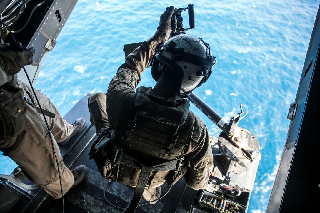 GULF OF OMAN (Oct. 29, 2015) U.S. Marine Cpl. Jordan Gomez prepares to fire an M240 medium machine gun from an MV-22B Osprey. Gomez is a crew chief with Marine Medium Tiltrotor Squadron 161 (Reinforced), 15th Marine Expeditionary Unit. The Marines practiced firing at targets in the water to stay familiar with the weapon system and enhance their marksmanship. The 15th MEU, embarked on the ships of the Essex Amphibious Ready Group, is deployed to maintain regional security in the U.S. 5th Fleet area of operations. (U.S. Marine Corps photo by Sgt. Anna Albrecht/Released)