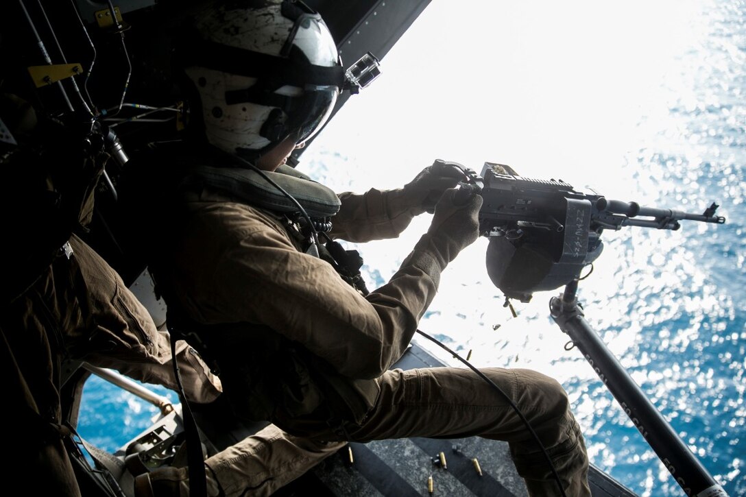 GULF OF OMAN (Oct. 29, 2015) U.S. Marine Cpl. Jordan Gomez fires an M240 medium machine gun from an MV-22B Osprey. Gomez is a crew chief with Marine Medium Tiltrotor Squadron 161 (Reinforced), 15th Marine Expeditionary Unit. The Marines practiced firing at targets in the water to stay familiar with the weapon system and enhance their marksmanship. The 15th MEU, embarked on the ships of the Essex Amphibious Ready Group, is deployed to maintain regional security in the U.S. 5th Fleet area of operations. (U.S. Marine Corps photo by Sgt. Anna Albrecht/Released)