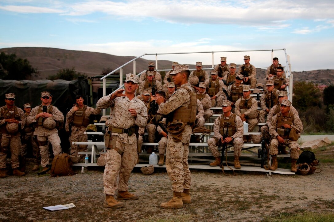 Gunnery Sgt. William T. Jones, left, headquarters commandant, and Lance Cpl. Angel Garcia, a cyber network operator, both with the 11th Marine Expeditionary Unit (MEU), demonstrate the proper technique of handling an M69 training grenade for an M67 live-fire grenade exercise during the 11th MEU Command Element field exercise (CEFEX) at Camp Pendleton, Calif. CEFEX marks the 11th MEU’s first field exercise prior to compositing the Marine Air Ground Task Force as they prepare for the WestPac 16-2 deployment. (U.S. Marine Corps photo by Cpl. Xzavior T. McNeal)