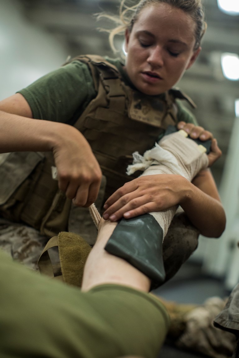 U.S. Marines Corporal Amy Bucklew with Battery “B”, 2nd Battalion, 1st Marine Regiment, raps the arm of a simulated casualty while participating in the Combat Life Saver Course during Composite Training Unit Exercise (COMPTUEX) aboard the USS NEW ORLEANS on Oct. 28, 2015. COMPTUEX provides the PHIBRON-MEU the opportunity to integrate planning while also allowing focused, mission-specific training and evaluation for the Marines and their Navy Counterparts. (U.S. Marine Corps photo by Sgt. Hector de Jesus/Released)