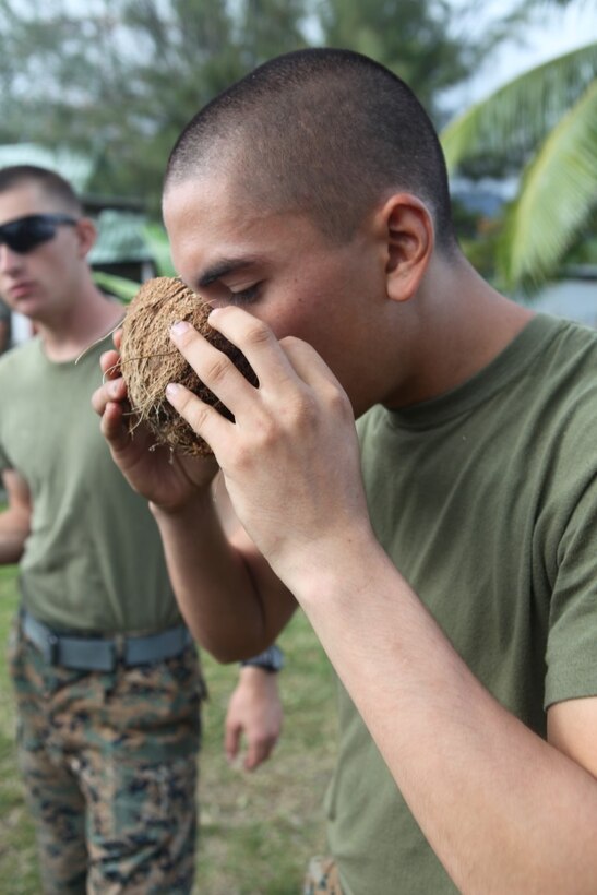 Lance Cpl. Kaedyn Griffith, a combat engineer for engineer platoon, Koa Moana 15-3, drinks coconut water during a cultural event in Tahiti, Oct. 1. Koa Moana (Ocean Warrior) aims to enhance senior military leader engagements between allied and partner nations, and also provides an opportunity for cultural insight between participating nations.