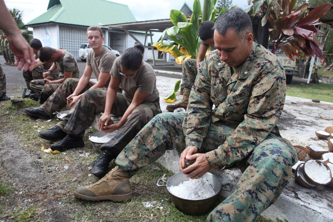 Lt. Col. Demetrius Bolduc, commanding officer for Koa Moana 15-3, prepares Tahitian food during a cultural event in Tahiti, Oct. 1. Marines also shared warfighting techniques and tactics during the training evolution with French forces.