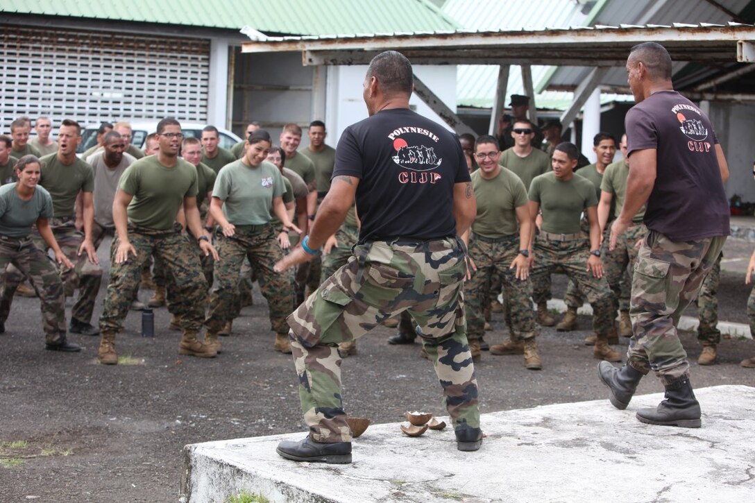Tahitians and Marines participate in a pre-meal dancing ritual prior to eating in Tahiti, Oct. 1 during exercise Koa Moana. Koa Moana (Ocean Warrior) is scheduled to take place in Honduras, Tahiti, Fiji, Vanuatu, Kiribati and Timor Leste to enhance senior military leader engagements between allied and partner nations.