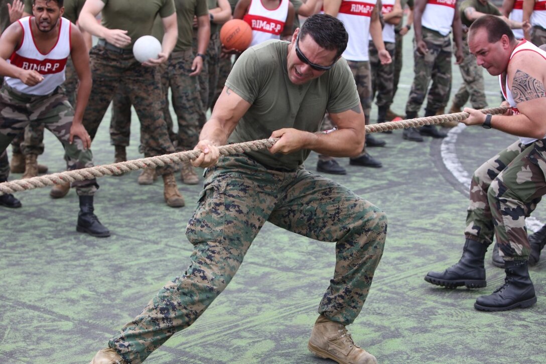 Gunnery Sgt. James Kines, platoon sergeant for law enforcement platoon, Koa Moana 15-3, participates in tug-o-war during cultural sporting events in Tahiti, Oct. 2. Throughout the week, Marines shared warfighting techniques and tactics with their French counterparts.