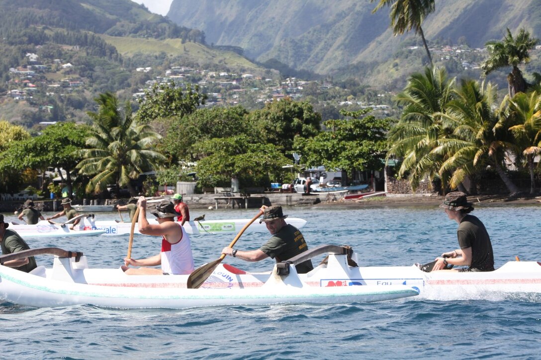Staff Sgt. Robert J. Houser, platoon sergeant for engineer platoon, Koa Moana 15-3 and Capt. Corey Goodwin, executive officer for Koa Moana 15-3, participate during an outrigger canoe event in Tahiti, Sept. 28. Marines also participated in a theatre security cooperation exercise with the French troops where they shared warfighting techniques and tactics.