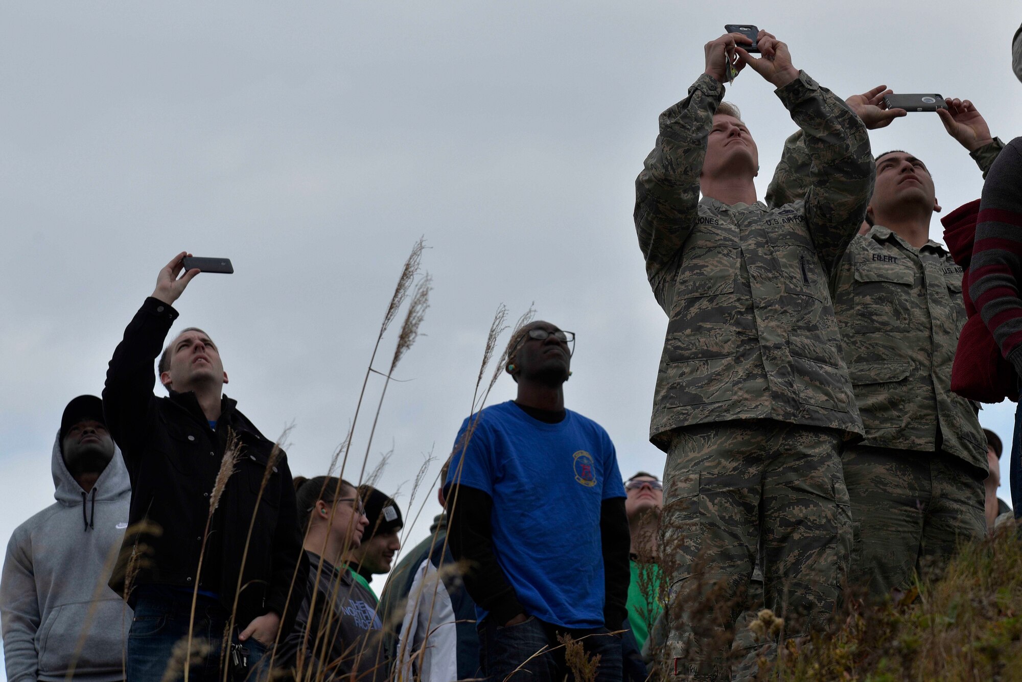 Range Day attendees look on as an F-16 Fighting Falcon conducts a flyover at Draughon Range outside Misawa Air Base, Japan, Oct. 30, 2015. More than 200 Airmen and family members attended Range Day, allowing them to experience Misawa's mission up-close and personal. (U.S. Air Force photo by Senior Airman Jose L. Hernandez-Domitilo)