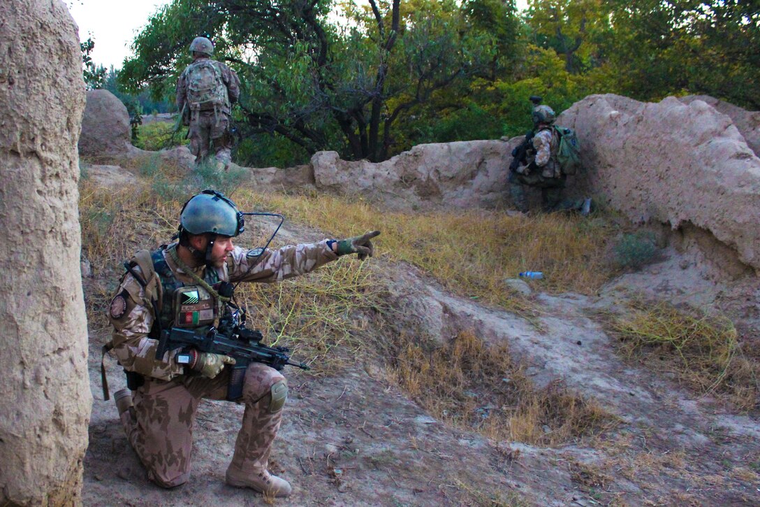 A Czech soldier points in the direction of movement as U.S. and Afghan soldiers patrol through a village in Parwan province, Afghanistan, Oct. 20, 2015. U.S. Army photo by Sgt. 1st Class David Wheeler