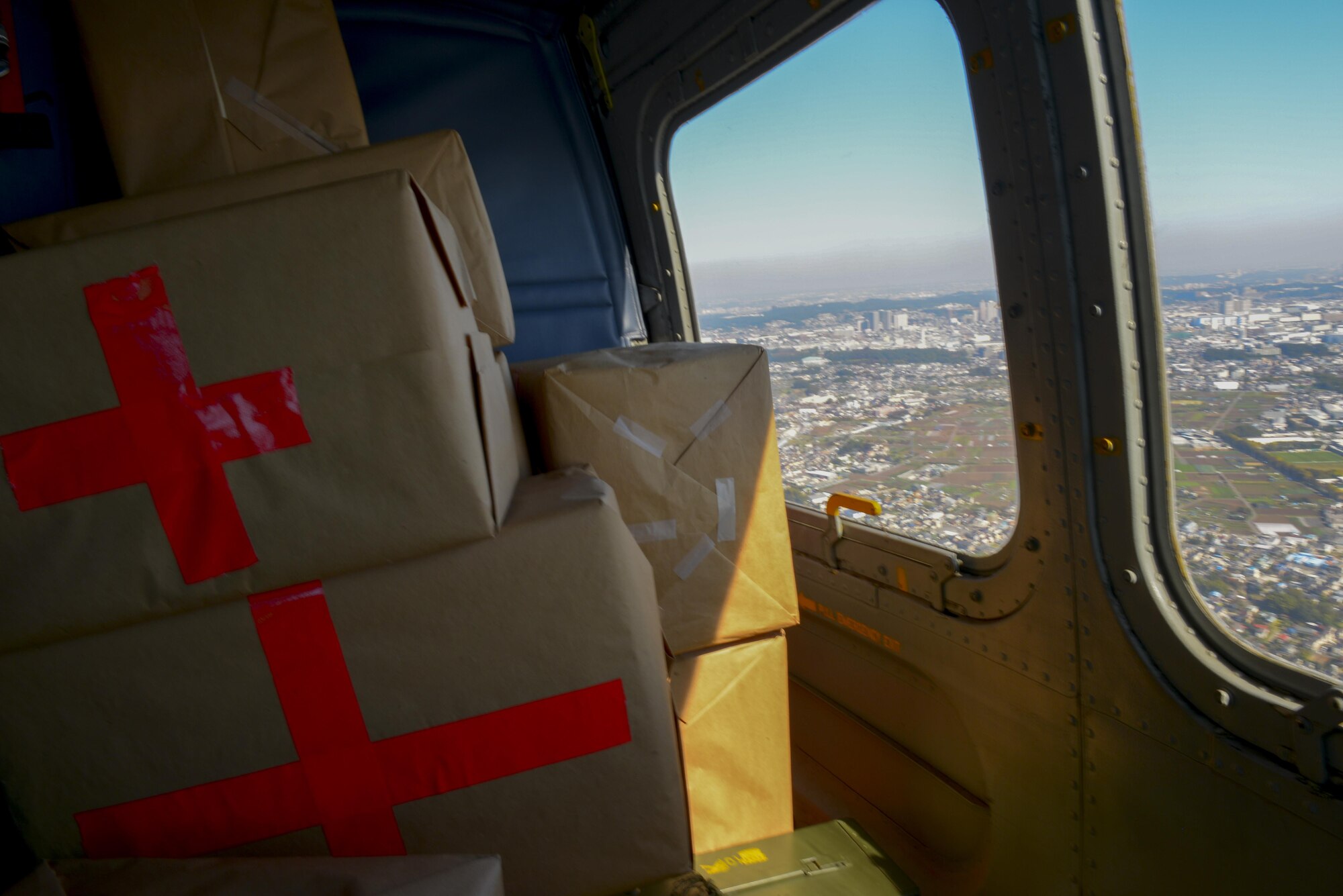 A UH-1N Huey transports simulated medical supplies to Miakejima Island for a Tokyo Metropolitan Government disaster relief exercise off the coast of Tokyo, Japan, Oct. 28, 2015. The UH-1N is suitable for disaster relief efforts because it requires very little space to operate and can land on a damaged runway. (U.S. Air Force photo by Airman 1st Class Elizabeth Baker/Released))