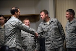 Lt. Gen. Stanley E. Clarke III, director of the Air National Guard, coins Master Sgt. Neil Allison for his outstanding performance at the 158th Fighter Wing, Vt., Oct. 17, 2015. Clarke visited Vermont, met with the Airmen and Vermont Air National Guard leadership.