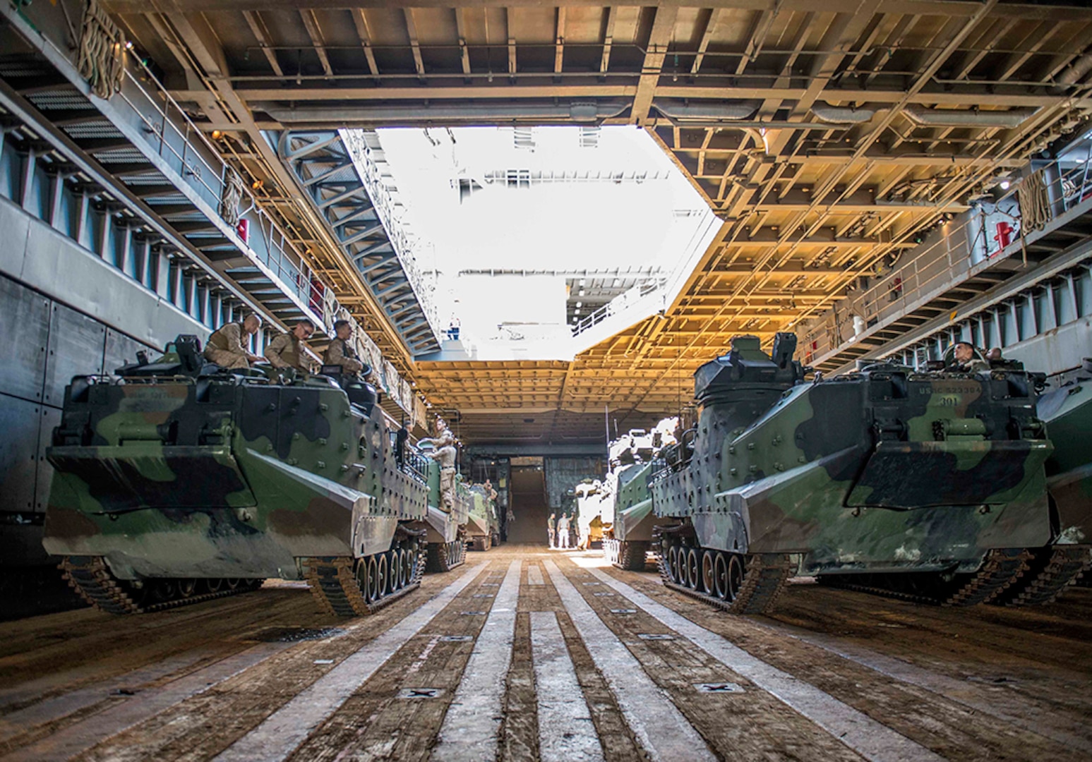 WATERS OFF OKINAWA, Japan – Amphibious assault vehicles wait in the well deck of the amphibious dock landing ship USS Germantown (LSD 42) before launching to head ashore for a personnel swap during exercise Blue Chromite (BC) 16. BC 16 is a U.S. only exercise designed to increase amphibious proficiency between the Navy and Marine Corps. 