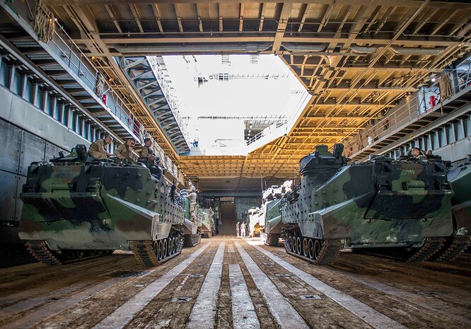 WATERS OFF OKINAWA, Japan – Amphibious assault vehicles wait in the well deck of the amphibious dock landing ship USS Germantown (LSD 42) before launching to head ashore for a personnel swap during exercise Blue Chromite (BC) 16. BC 16 is a U.S. only exercise designed to increase amphibious proficiency between the Navy and Marine Corps. 