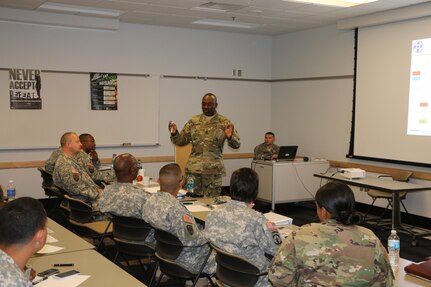 The 310th Sustainment Command (Expeditionary) senior enlisted adviser Command Sgt. Maj. Levi G. Maynard, speaks at the Indianapolis Recruiting Battalion Partnership Zone Conference focused on implementing the Army’s total force policy at Fort Benjamin Harrison, Ind., Oct. 24, 2015. Leaders from the Army Reserve’s 310th Sustainment Command (Expeditionary), Indiana Reserve Officer Training Corps (ROTC), the Army Reserve Careers Division (ARCD), and the U.S. Army’s Recruiter Battalion Indianapolis (USAREC) gathered at the Spc. Luke P. Frist Army Reserve Center on Fort Benjamin Harrison to coordinate focused recruiting support for the Army’s Total Force policy.