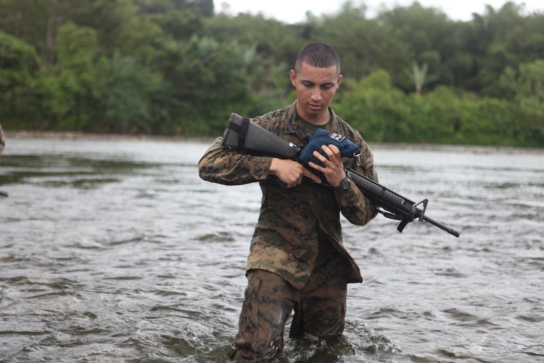 Cpl. Renatto Aguilar, administrative clerk for KOA MOANA 15-3, takes a break after hiking in the jungle during a training exercise in Namosi Province, Fiji, Oct. 13. Marines also helped build up the local communities during the evolution.