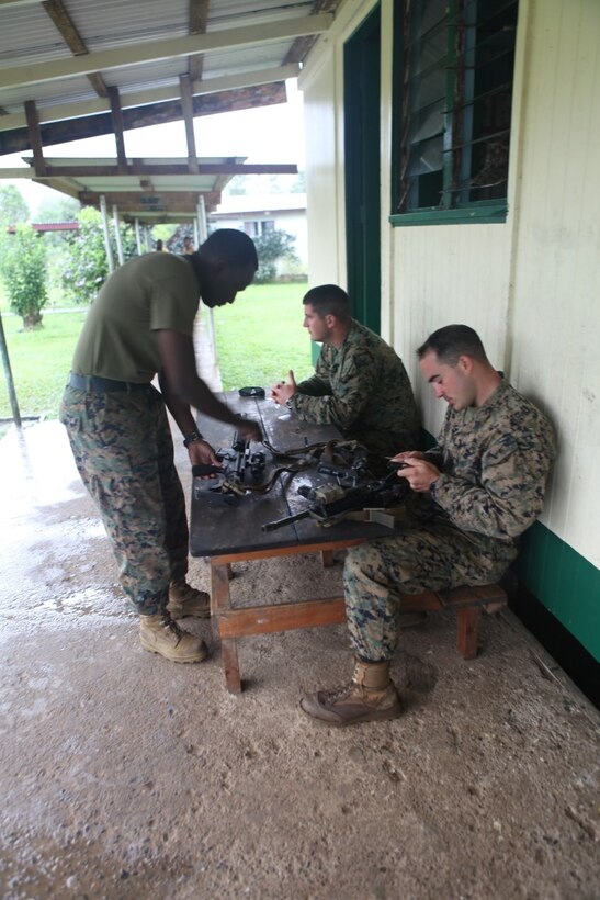 Sgt. Daniel Knight, a squad leader in Law Enforcement Platoon KOA MOANA 15-3, cleans his weapon during a training exercise in Namosi Province, Fiji, Oct. 15. Marines trained with members of the Republic of Fiji Military Force.