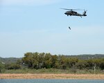 A Texas Army National Guard Sikorsky UH-60 Black Hawk hoists a member from the Federal Emergency Management Agency's Texas Task Force 1 during a search and rescue exercise at Canyon Lake, Texas, April 11, 2014. The joint, interagency exercise simulated emergency response following a hurricane, with members from the Texas Air National Guard, Texas Army National Guard, Texas Task Force 1, the U.S. Coast Guard and Texas Department of Public Safety integrating to form a joint response team. (U.S. Air National Guard photo by 2nd Lt. Alicia Lacy/ Released)