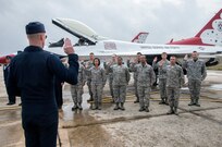 Lt. Col. Christopher Hammond, commander/leader of the U.S. Air Force Air Demonstration Squadron, administered the oath of enlistment to members of Joint Base San Antonio Oct. 30, 2015, as part of the events leading up to the JBSA Air Show & Open House at JBSA-Randolph. In attendance were friends and family who witnessed the reenlistment followed by the Thunderbirds practice performance. (U.S. Air Force photo by photo by Johnny Saldivar)