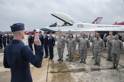 Lt. Col. Christopher Hammond, commander/leader of the U.S. Air Force Air Demonstration Squadron, administered the oath of enlistment to members of Joint Base San Antonio Oct. 30, 2015, as part of the events leading up to the JBSA Air Show & Open House at JBSA-Randolph. In attendance were friends and family who witnessed the reenlistment followed by the Thunderbirds practice performance. (U.S. Air Force photo by photo by Johnny Saldivar)