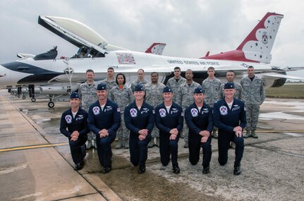 U.S. Air Force Aerial Demonstration Squadron “Thunderbirds” officers pose for a group photo with Joint Base San Antonio enlisted members who reenlisted Oct. 30, 2015, as part of the events leading up to the JBSA Air Show & Open House at JBSA-Randolph. In attendance were friends and family who witnessed the reenlistment followed by the Thunderbirds practice performance. (U.S. Air Force photo by photo by Johnny Saldivar)