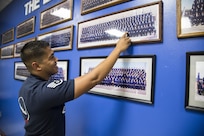 Staff Sgt. Matthew Gips, Thunderbirds knowledge operations manager, points at himself within a Judson High School Junior Reserve Officers Corps picture from his time as a student there. Gips and fellow previous JHS student and Thunderbirds teammate Maj. Christopher Scheibler took the opportunity to demonstrate the mission of the Thunderbirds air demonstration team and to motivate current JHS students to work hard on their academics and have a plan as they approach adult life. 