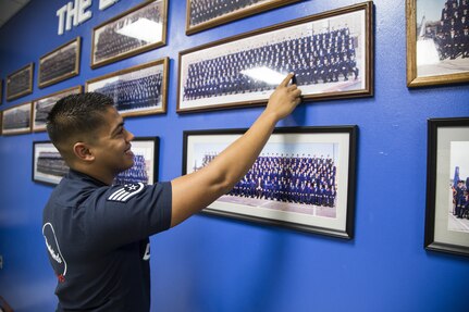 Staff Sgt. Matthew Gips, Thunderbirds knowledge operations manager, points at himself within a Judson High School Junior Reserve Officers Corps picture from his time as a student there. Gips and fellow previous JHS student and Thunderbirds teammate Maj. Christopher Scheibler took the opportunity to demonstrate the mission of the Thunderbirds air demonstration team and to motivate current JHS students to work hard on their academics and have a plan as they approach adult life. 