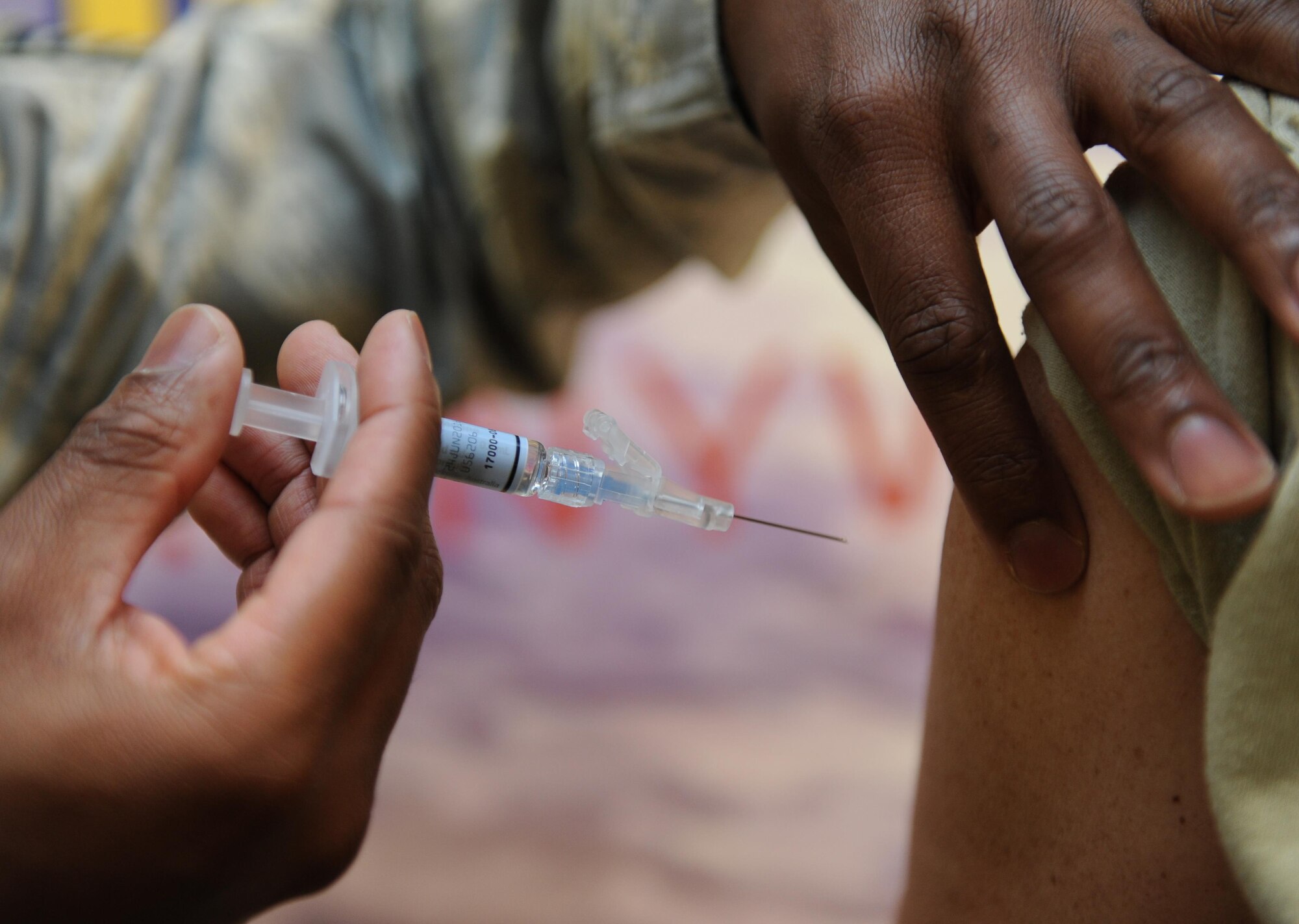 Staff Sgt. Johnel Collins, 81st Medical Operations Squadron allergy and immunizations technician, administers the influenza vaccine to Col. Michele Edmondson, 81st Training Wing commander, in the Keesler Medical Center, Oct. 30, 2015, Keesler Air Force Base, Miss. With the start of flu season, the 81st MDOS Immunizations Clinic is providing the vaccine to those eligible in the Keesler community. The clinic is open to all active-duty, dependents, retirees and Defense Department employees. The clinic is walk-in only on a first-come, first-served basis. Clinic hours are: Mondays and Wednesdays, 8 a.m.-4:30 p.m., Tuesdays and Thursdays, 7 a.m.-4:30 p.m. and Fridays, 7 a.m.-11:30 a.m. and 1-4 p.m. The clinic is closed every second Thursday for training. (U.S. Air Force photo by Kemberly Groue)